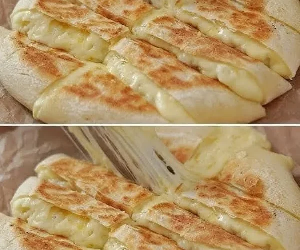 Pan de ajo con queso servido en un plato, ideal para acompañar comidas.